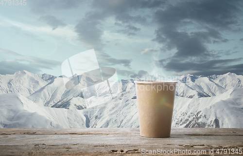 Image of Single tea or coffee mug and landscape of mountains on background