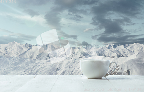 Image of Single tea or coffee mug and landscape of mountains on background