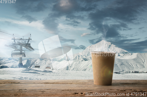 Image of Single tea or coffee mug and landscape of mountains on background