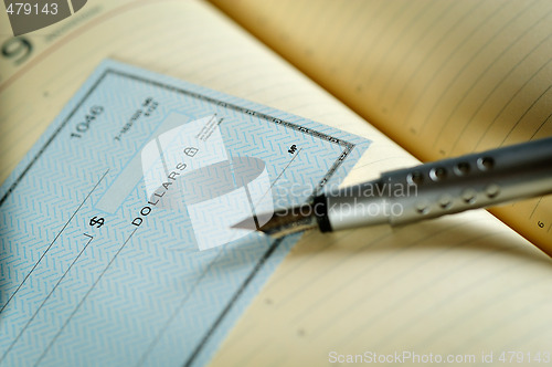 Image of money check and pen