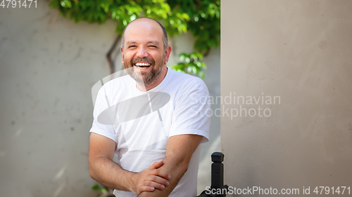 Image of bearded bald man laughing