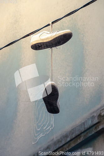 Image of old shoes hanging on a wire