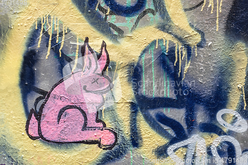 Image of pink graffiti rabbit painting on a wall
