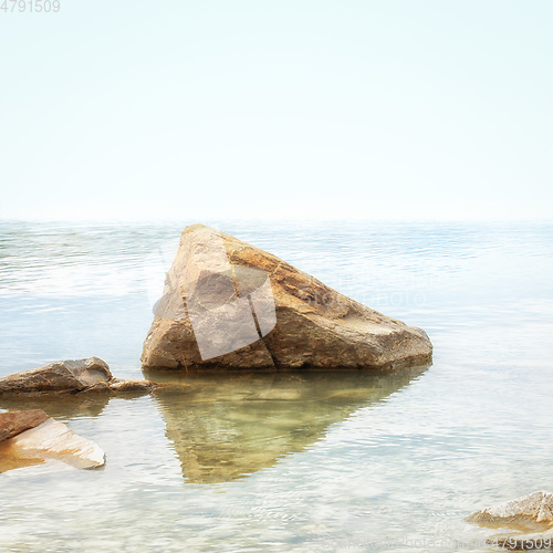 Image of red rock in the lake