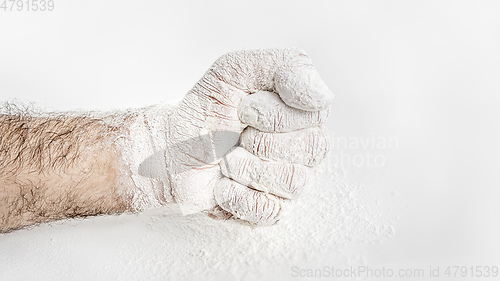 Image of male fist covered in flour