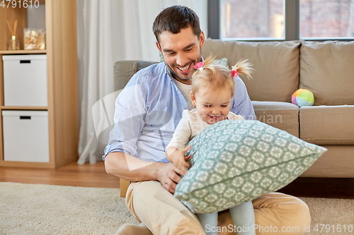 Image of father with little baby daughter at home