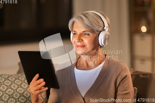 Image of senior woman in headphones listening to music