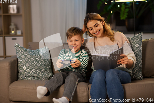 Image of happy mother with little son spending time at home