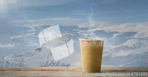 Image of Single tea or coffee mug and landscape of mountains on background