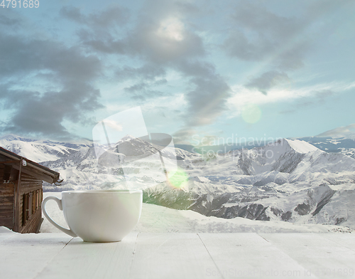 Image of Single tea or coffee mug and landscape of mountains on background