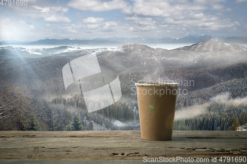 Image of Single tea or coffee mug and landscape of mountains on background