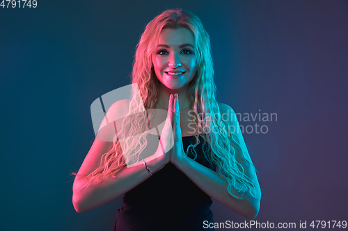 Image of Caucasian young woman\'s portrait on gradient background in neon light