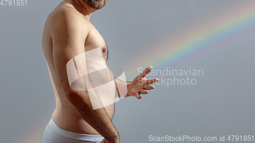 Image of naked man and a rainbow