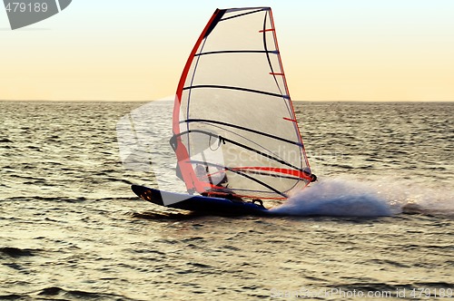 Image of Silhouette of a windsurfer on a gulf, moving at great speed
