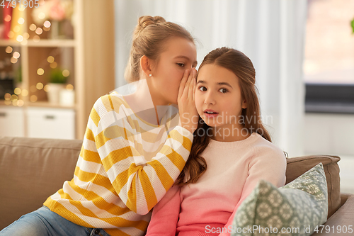 Image of teenage girls gossiping at home