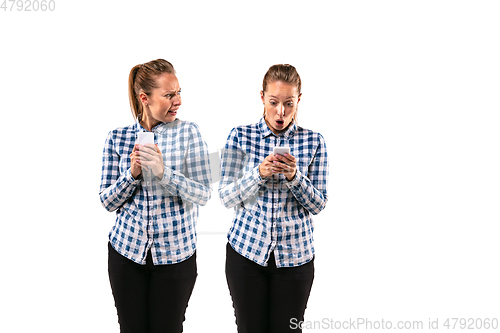 Image of Young handsome woman arguing with herself on white studio background.