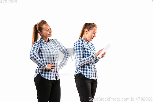 Image of Young handsome woman arguing with herself on white studio background.