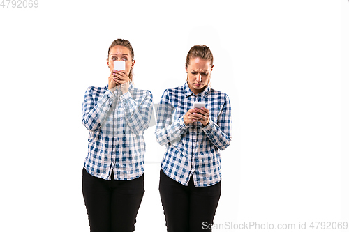 Image of Young handsome woman arguing with herself on white studio background.