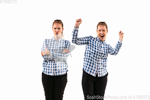 Image of Young handsome woman arguing with herself on white studio background.