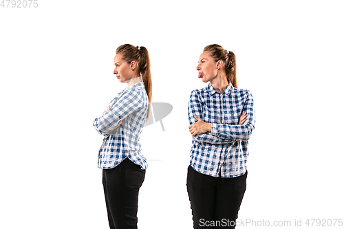 Image of Young handsome woman arguing with herself on white studio background.