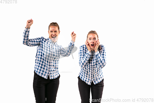 Image of Young handsome woman arguing with herself on white studio background.