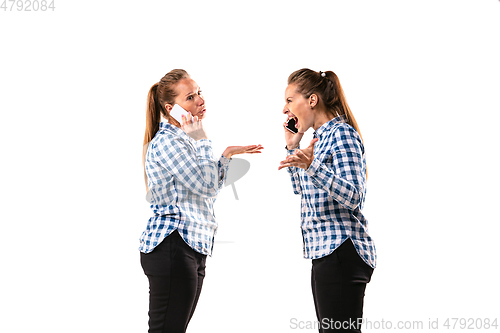 Image of Young handsome woman arguing with herself on white studio background.