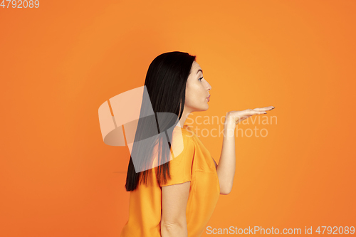 Image of Caucasian young woman\'s portrait on orange background