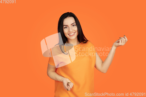 Image of Caucasian young woman\'s portrait on orange background