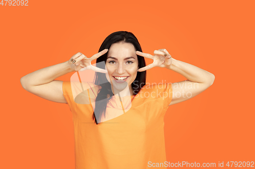 Image of Caucasian young woman\'s portrait on orange background