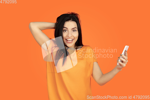 Image of Caucasian young woman\'s portrait on orange background