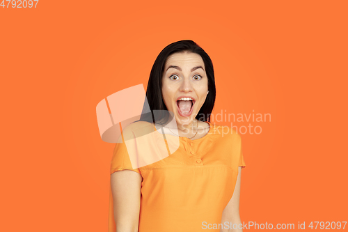 Image of Caucasian young woman\'s portrait on orange background