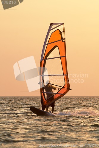 Image of Windsurfer on waves of a gulf on a sunset