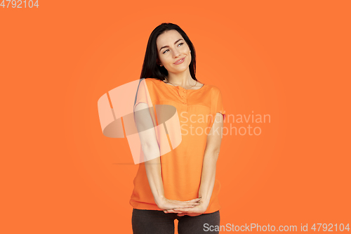 Image of Caucasian young woman\'s portrait on orange background