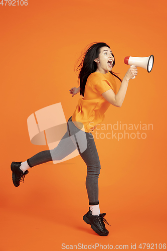 Image of Caucasian young woman\'s portrait on orange background