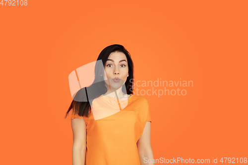 Image of Caucasian young woman\'s portrait on orange background