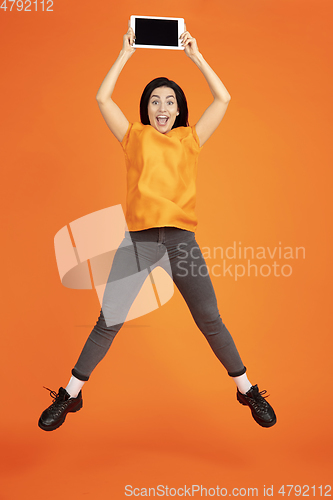 Image of Caucasian young woman\'s portrait on orange background