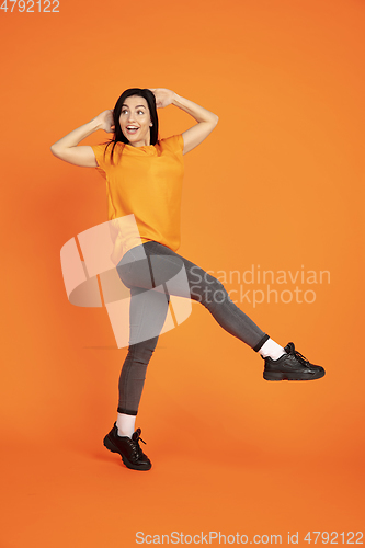 Image of Caucasian young woman\'s portrait on orange background