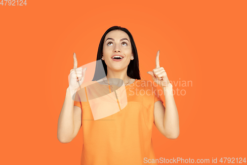 Image of Caucasian young woman\'s portrait on orange background