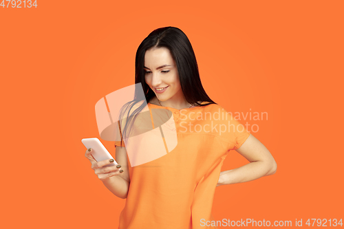 Image of Caucasian young woman\'s portrait on orange background