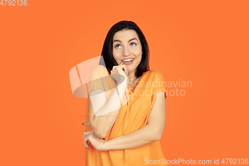 Image of Caucasian young woman\'s portrait on orange background