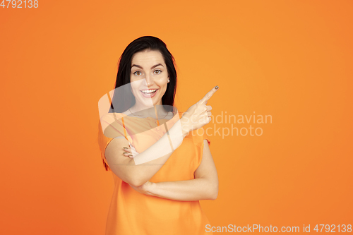 Image of Caucasian young woman\'s portrait on orange background