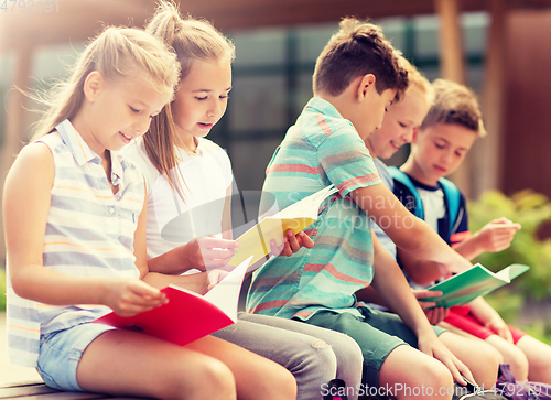 Image of group of happy elementary school students outdoors