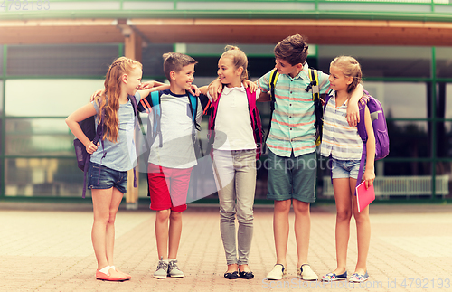 Image of group of happy elementary school students hugging