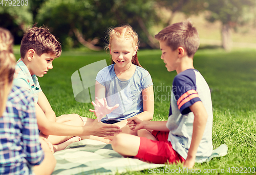 Image of happy kids playing rock-paper-scissors game
