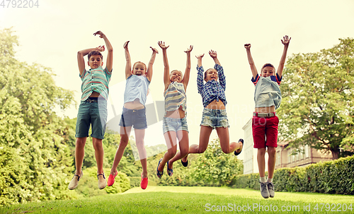 Image of happy kids jumping and having fun in summer park
