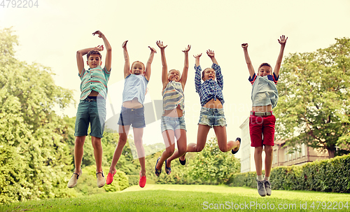 Image of happy kids jumping and having fun in summer park