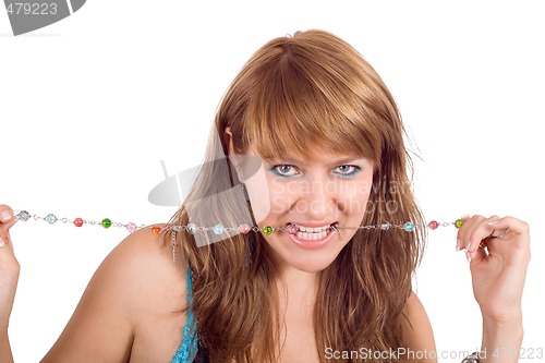 Image of Portrait of the young beautiful woman with a beads in a teeth