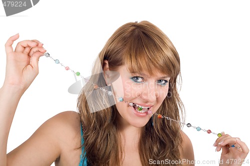 Image of Portrait of the young beautiful woman with a beads in a teeth. I
