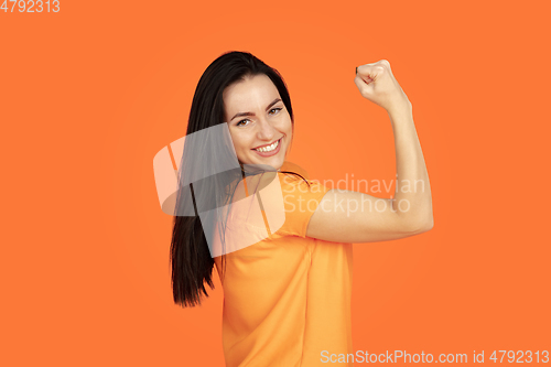 Image of Caucasian young woman\'s portrait on orange background