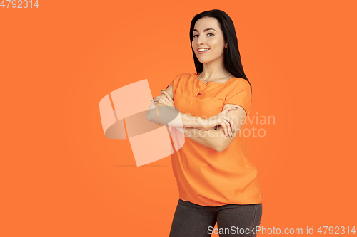 Image of Caucasian young woman\'s portrait on orange background